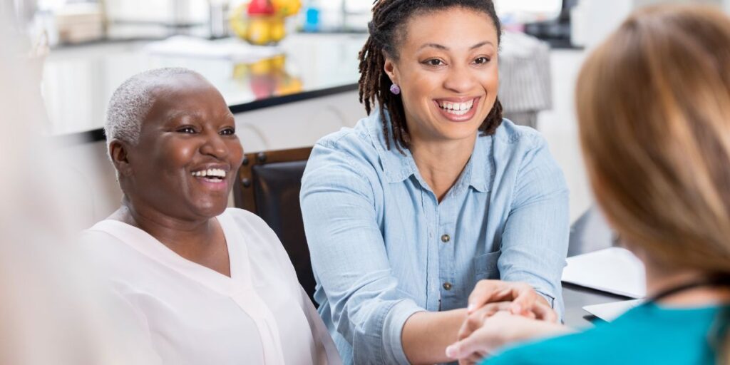Home support worker assisting an elderly person with daily activities in a cozy living room setting.